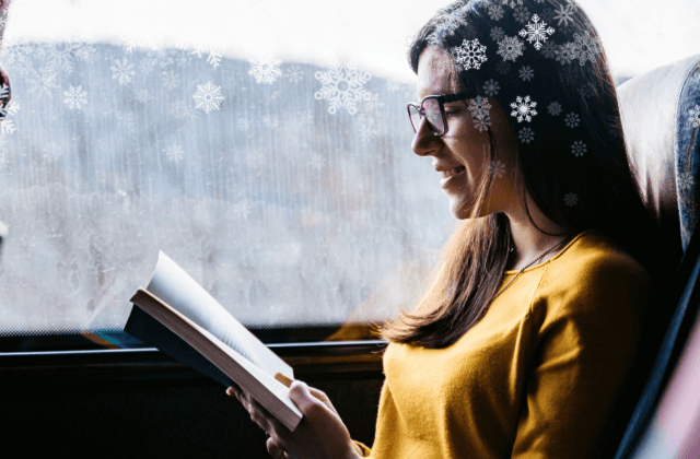 woman enjoying a book while on public transit