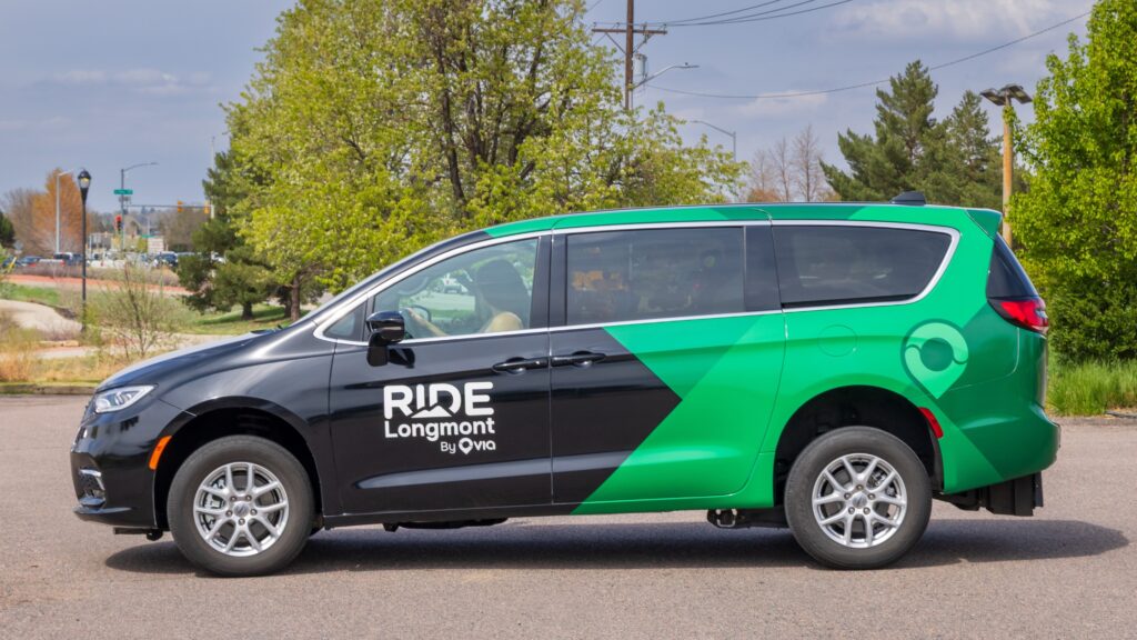 A parked black and green Ride Longmont van.